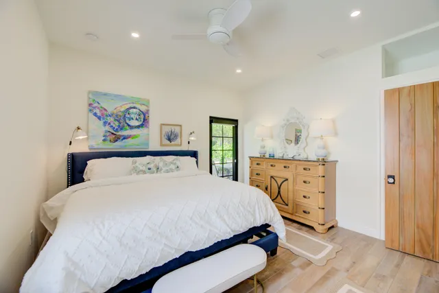 a bedroom with a bed and a dresser in it