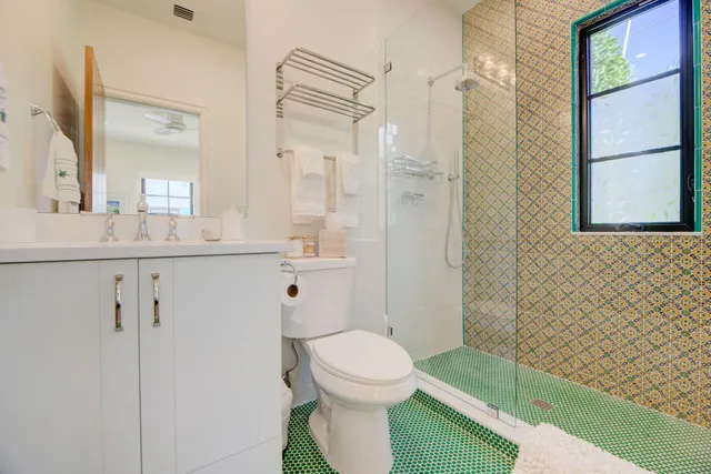 a bathroom with a sink toilet and shower