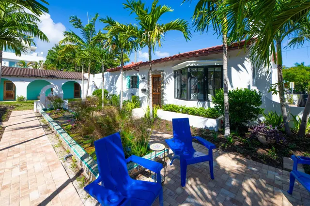 a view of a house with a yard patio and a fire pit