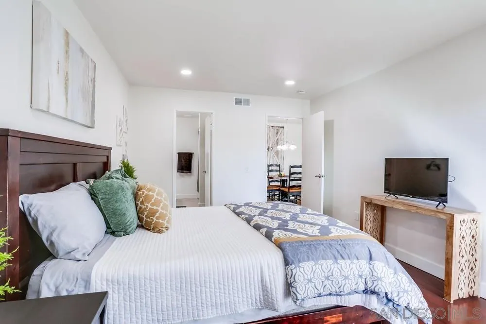 6314 Friars Road, Unit 116 San Diego, CA 92108 - Photo 15 of 36 a bedroom with a bed and a flat screen tv