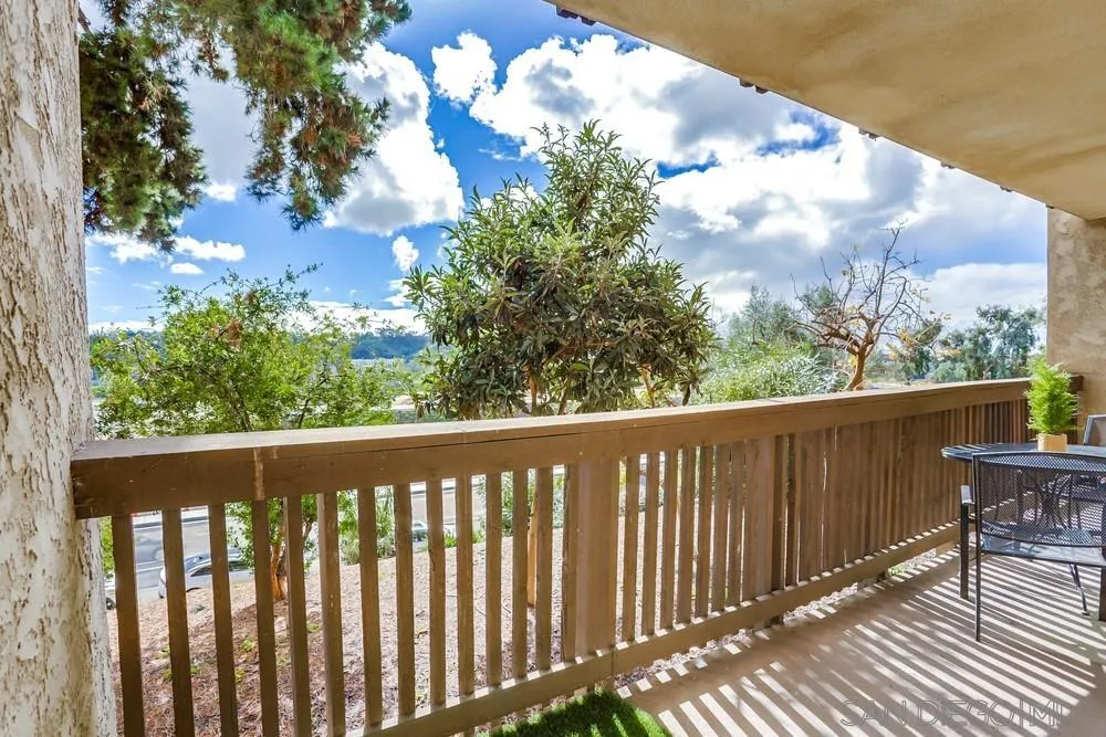 6314 Friars Road, Unit 116 San Diego, CA 92108 - Photo 20 of 36 a balcony with wooden floor and fence