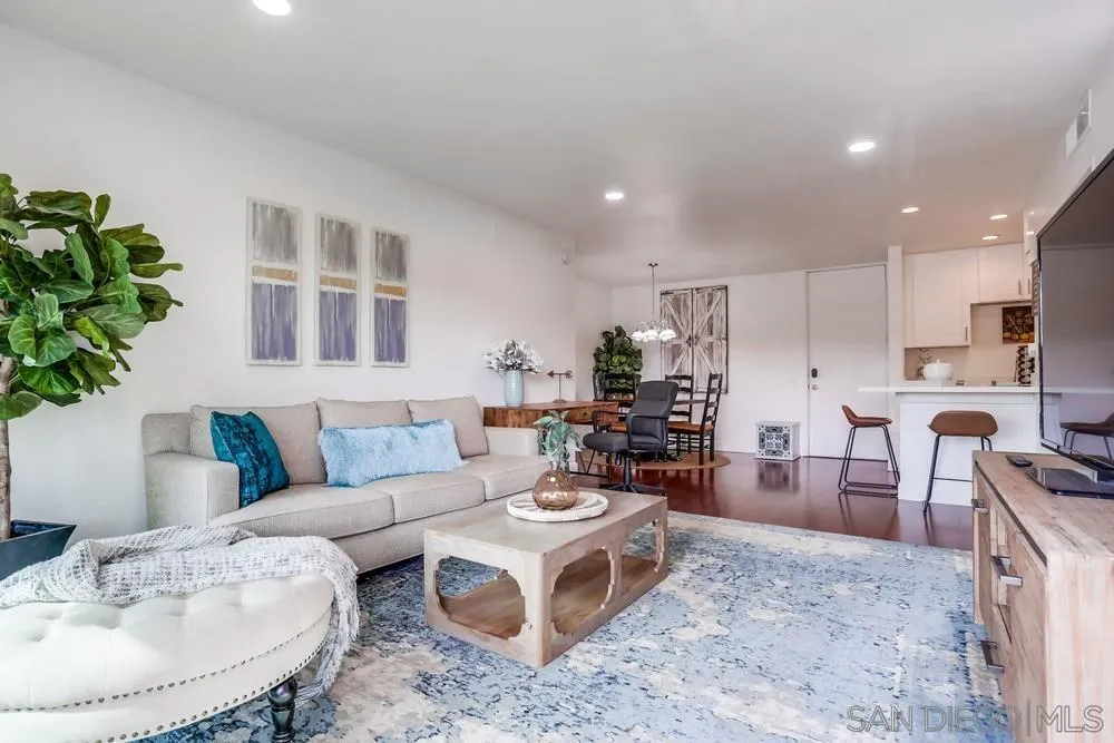 6314 Friars Road, Unit 116 San Diego, CA 92108 - Photo 8 of 36 a living room with furniture and a dining table with kitchen view