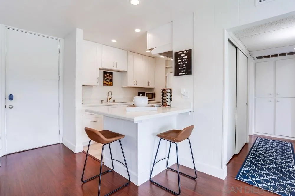 6314 Friars Road, Unit 116 San Diego, CA 92108 - Photo 9 of 36 a kitchen with stainless steel appliances granite countertop a refrigerator and a stove top oven