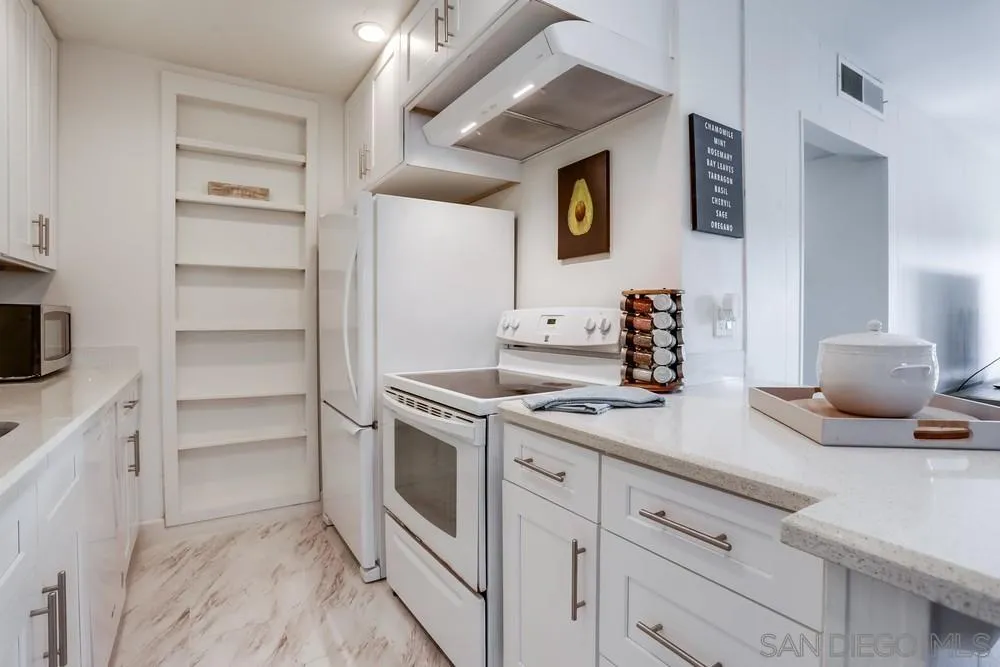 6314 Friars Road, Unit 116 San Diego, CA 92108 - Photo 10 of 36 a kitchen with a sink and cabinets