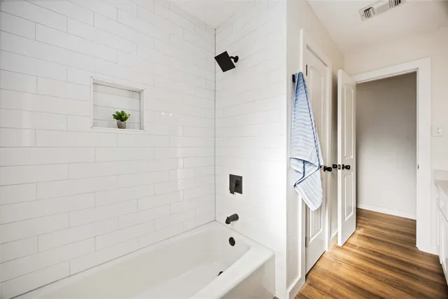 a bathroom with a bathtub and shower
