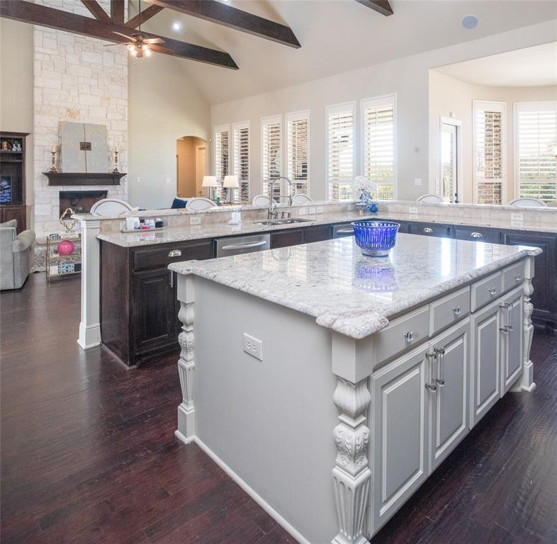 811 Red Store Court Lucas, TX 75002 - Photo 12 of 31 a kitchen with kitchen island granite countertop a sink cabinets and wooden floor
