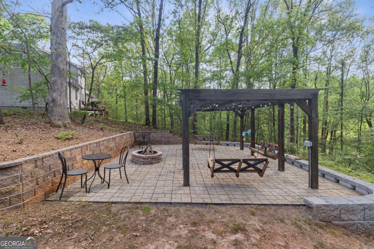 513 South Red Rock Road Toccoa, GA 30577 - Photo 11 of 47 a view of a patio with lawn chairs next to a yard