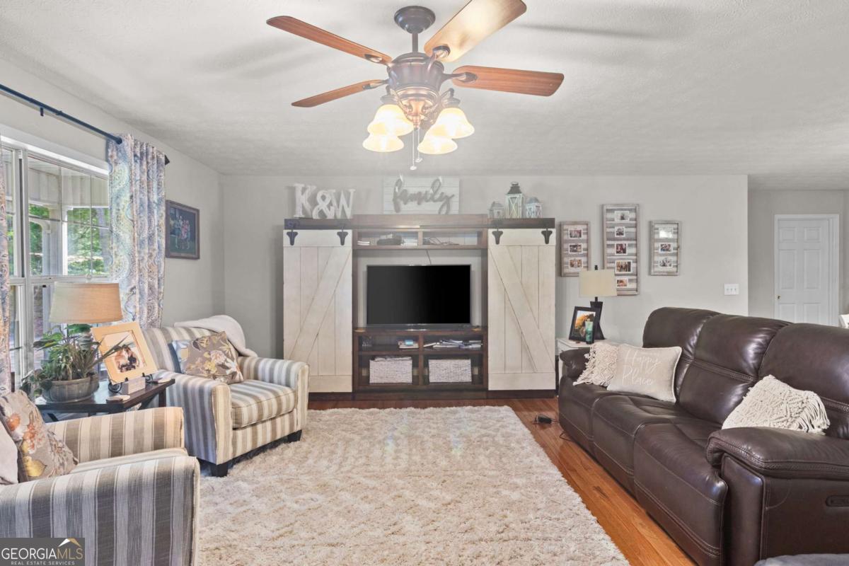513 South Red Rock Road Toccoa, GA 30577 - Photo 14 of 47 a living room with furniture and a chandelier