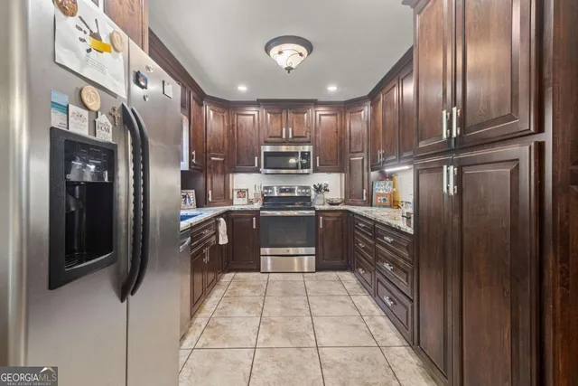 a kitchen with granite countertop stainless steel appliances and cabinets
