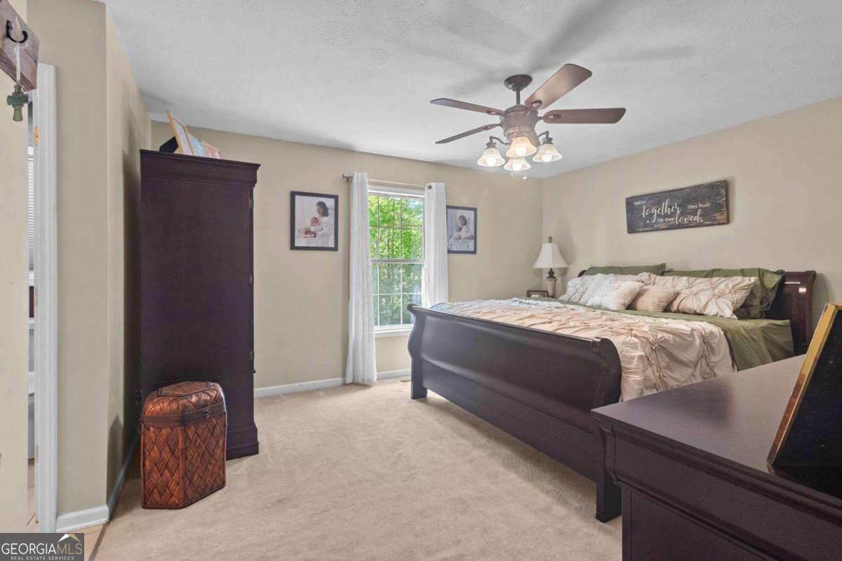 513 South Red Rock Road Toccoa, GA 30577 - Photo 23 of 47 a bedroom with a bed and a chandelier