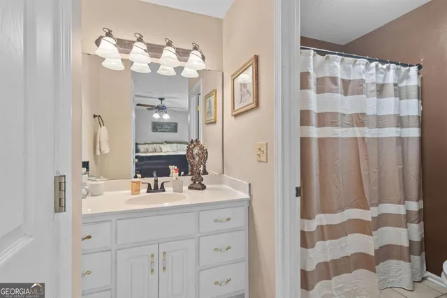 a spacious bedroom with a bed and a dresser