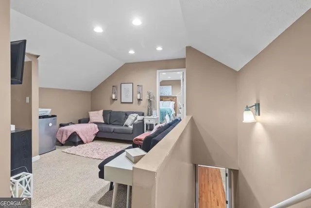 a white toilet sitting next to a bathroom sink and a mirror