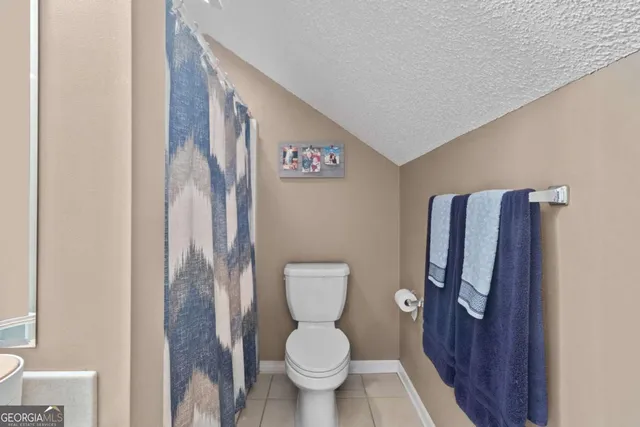 a kitchen with a sink and chairs