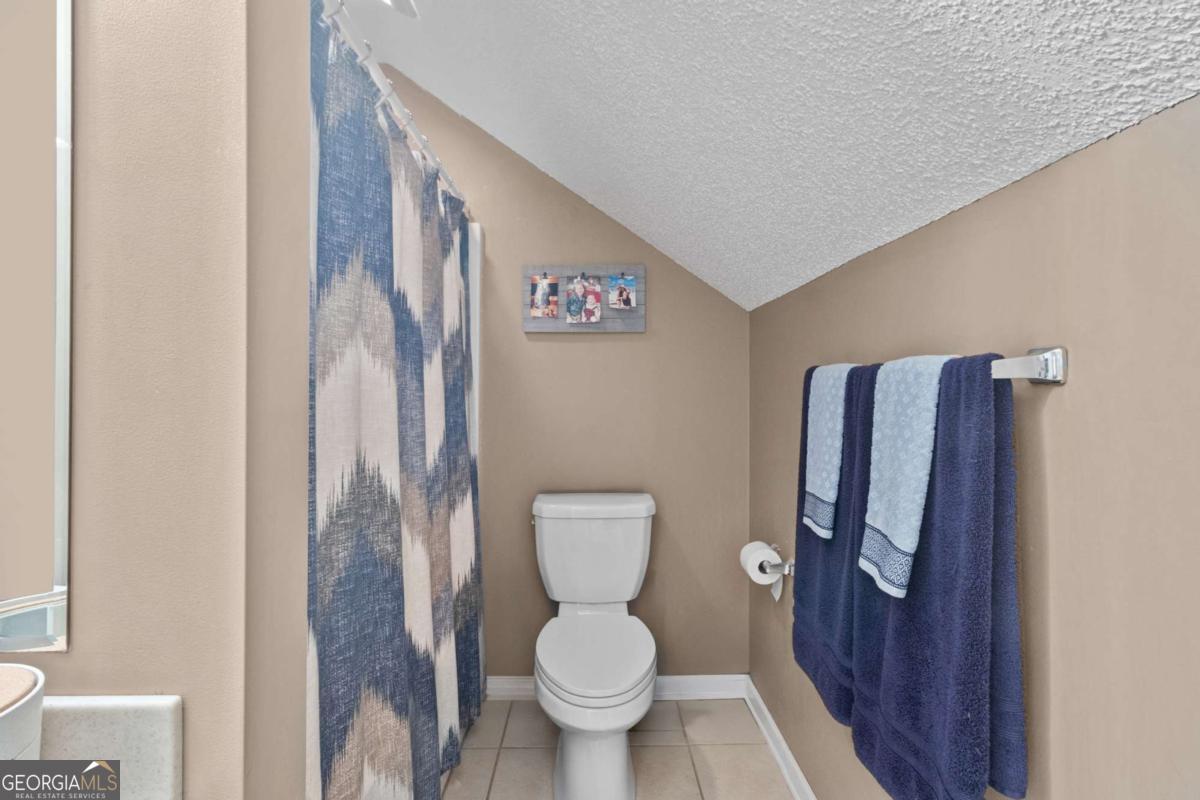 513 South Red Rock Road Toccoa, GA 30577 - Photo 29 of 47 a white toilet sitting next to a bathroom sink and a mirror