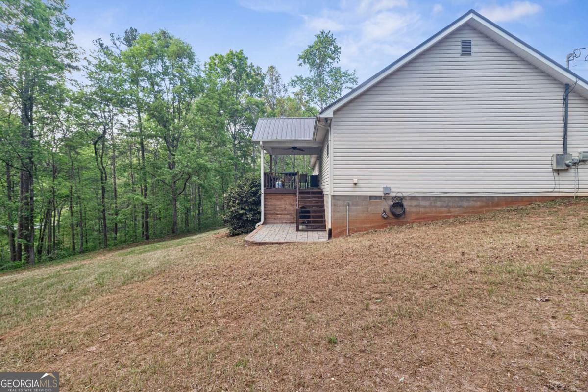 513 South Red Rock Road Toccoa, GA 30577 - Photo 7 of 47 a backyard of a house with table and chairs