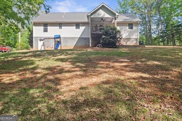 a patio with table and chairs and wooden floor
