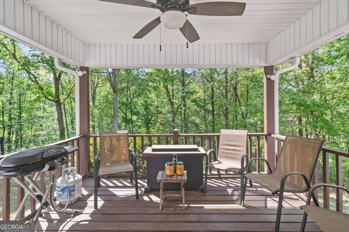 513 South Red Rock Road Toccoa, GA 30577 - Photo 9 of 47 a patio with table and chairs and wooden floor