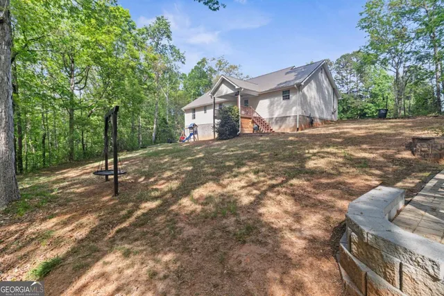 a view of a patio with lawn chairs next to a yard