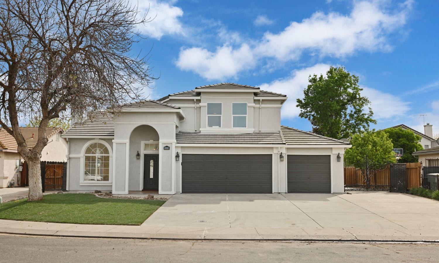 1212 McKnight Court Modesto, CA 95351 - Photo 1 of 1 a front view of a house with a garden