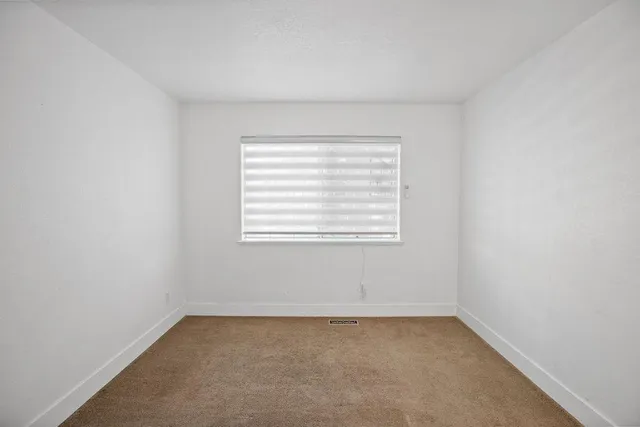 a view of a patio with a table and chairs