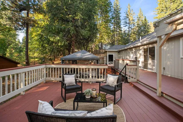 a view of a patio with a table and chairs under an umbrella