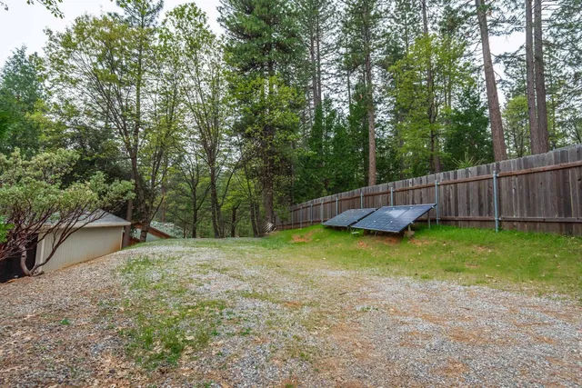 an aerial view of a house with garden space and street view