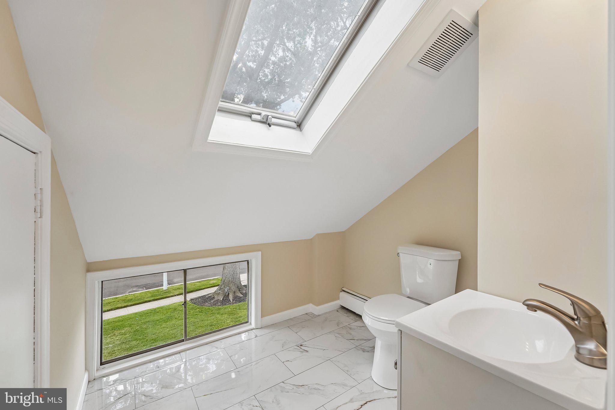 9 Rustleaf Lane Levittown, PA 19055 - Photo 18 of 45 Bright, airy bathroom with skylight.