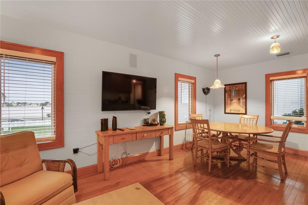 702 Pass A Grille Way St. Pete Beach, FL 33706 - Photo 28 of 41 a living room with furniture and a flat screen tv