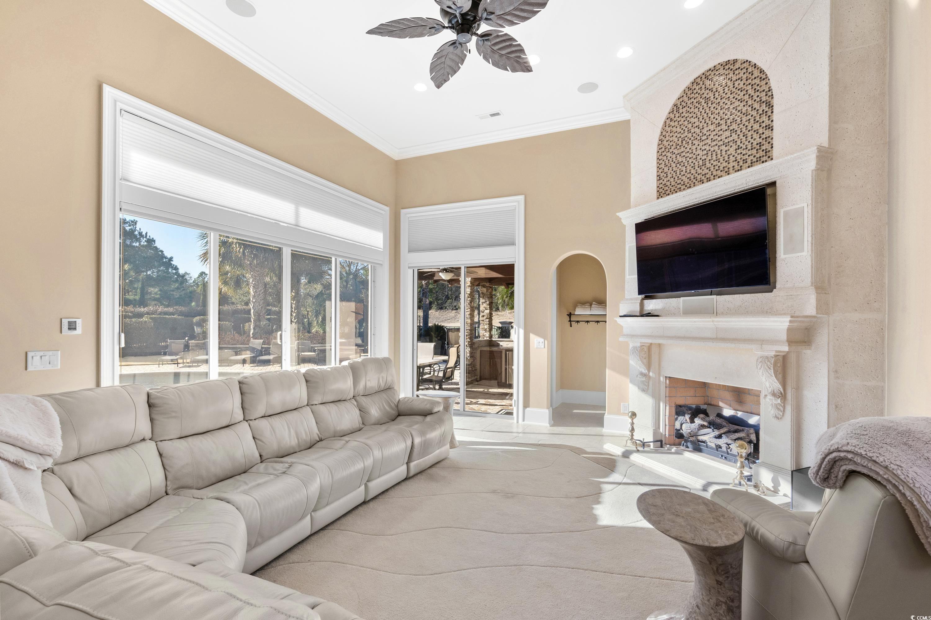 9237 Bellasera Circle Myrtle Beach, SC 29579 - Photo 15 of 34 Living area featuring a high end fireplace, ceiling fan, crown molding, and recessed lighting