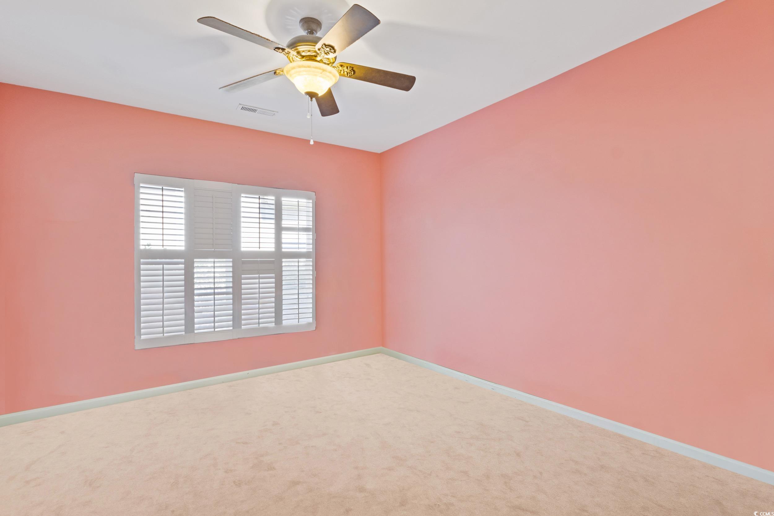 9237 Bellasera Circle Myrtle Beach, SC 29579 - Photo 18 of 34 Carpeted spare room with baseboards and ceiling fan