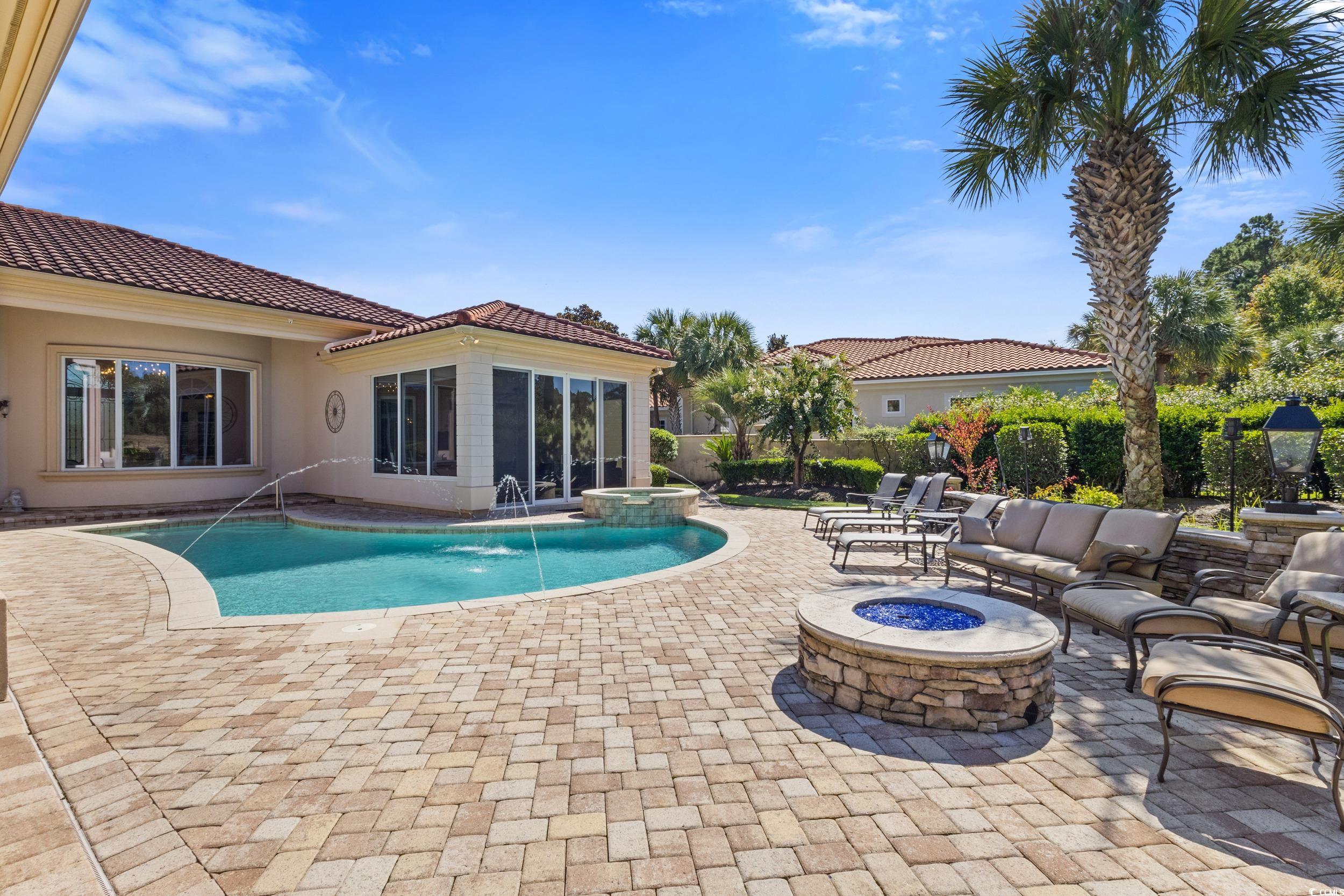 9237 Bellasera Circle Myrtle Beach, SC 29579 - Photo 29 of 34 View of pool with a patio area, a fire pit, and a pool with connected hot tub