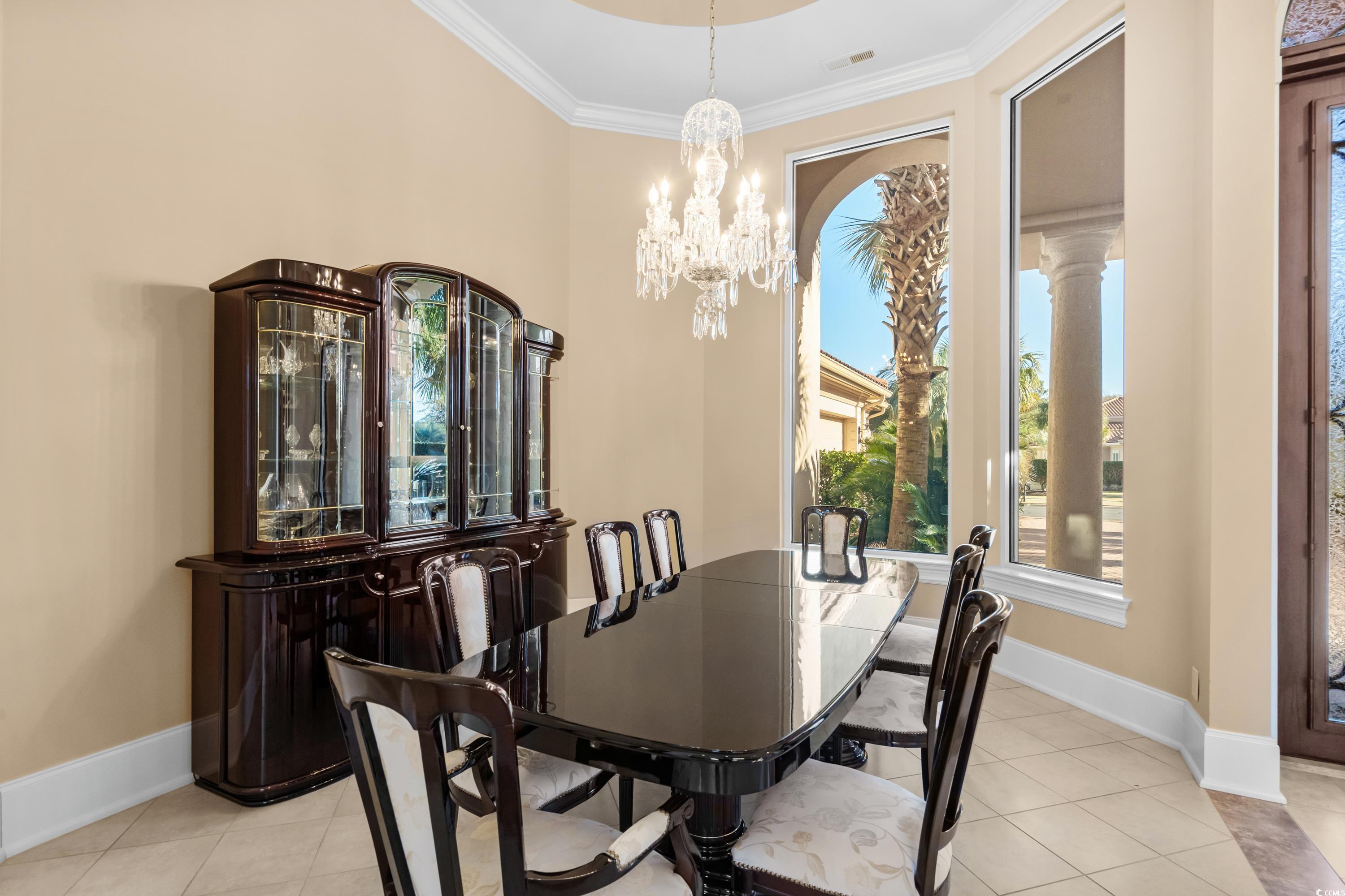 9237 Bellasera Circle Myrtle Beach, SC 29579 - Photo 3 of 34 Dining area with healthy amount of natural light, ornamental molding, a chandelier, and light tile patterned flooring