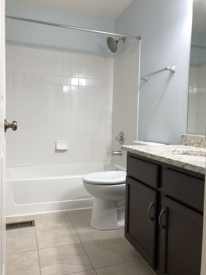 2330 Sheehan Drive Naperville, IL 60564 - Photo 15 of 18 a bathroom with a sink a toilet and a bathtub