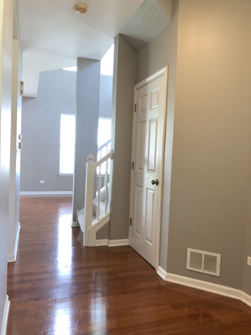 2330 Sheehan Drive Naperville, IL 60564 - Photo 3 of 18 a view of a hallway with wooden floor