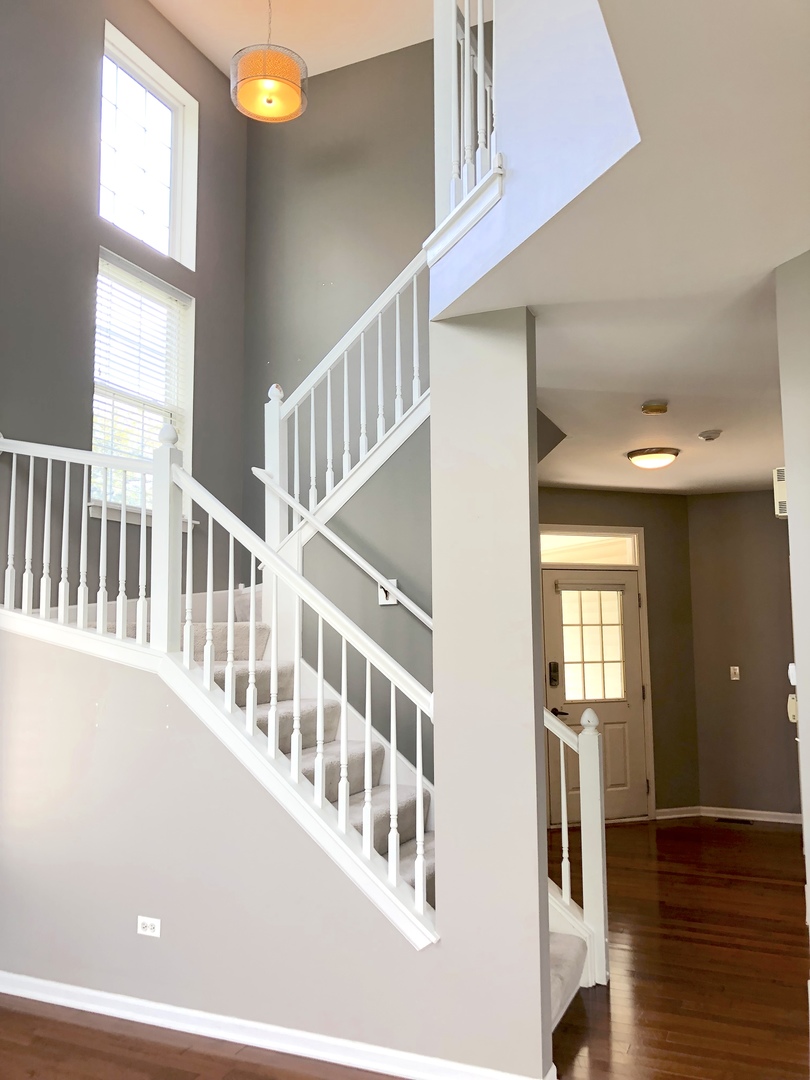 2330 Sheehan Drive Naperville, IL 60564 - Photo 4 of 18 a view of an entryway with wooden floor and windows