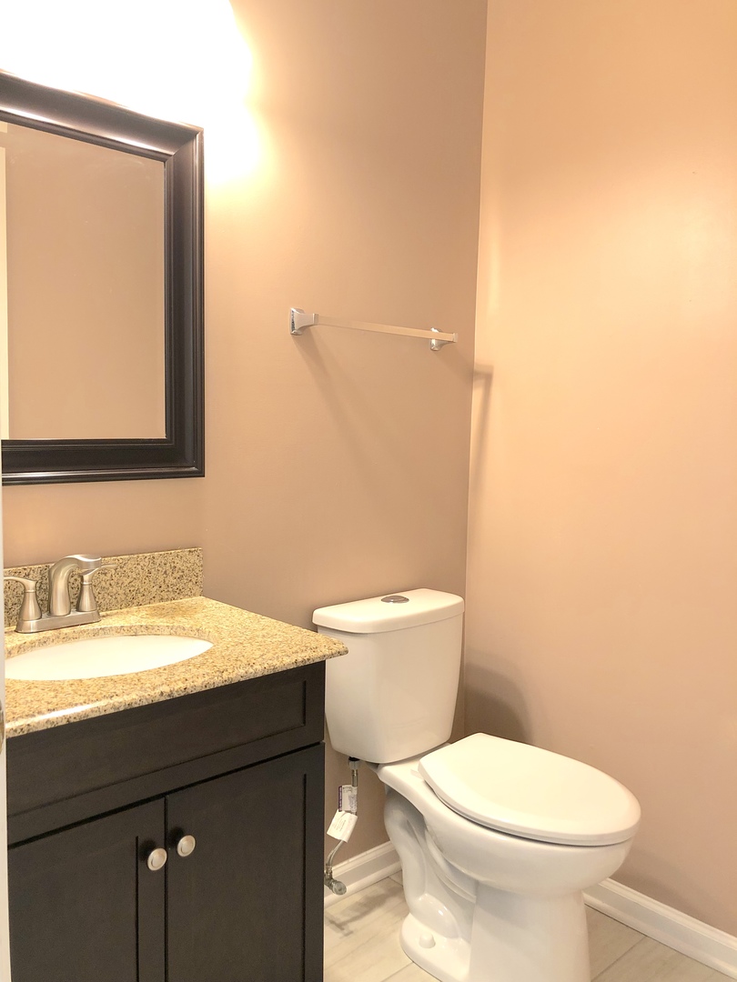 2330 Sheehan Drive Naperville, IL 60564 - Photo 5 of 18 a bathroom with a toilet a sink and mirror