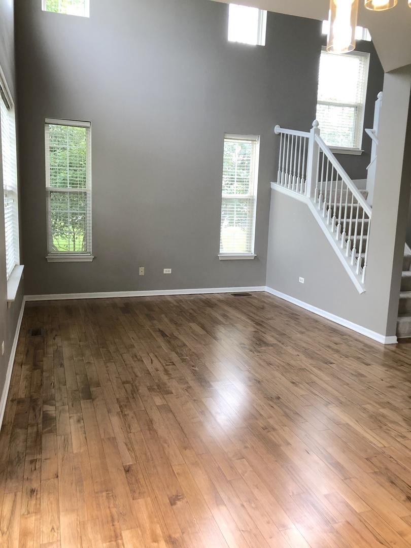 2330 Sheehan Drive Naperville, IL 60564 - Photo 6 of 18 an empty room with wooden floor and windows