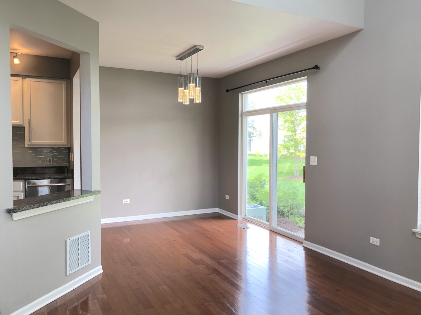 2330 Sheehan Drive Naperville, IL 60564 - Photo 7 of 18 a view of an empty room with wooden floor and a window