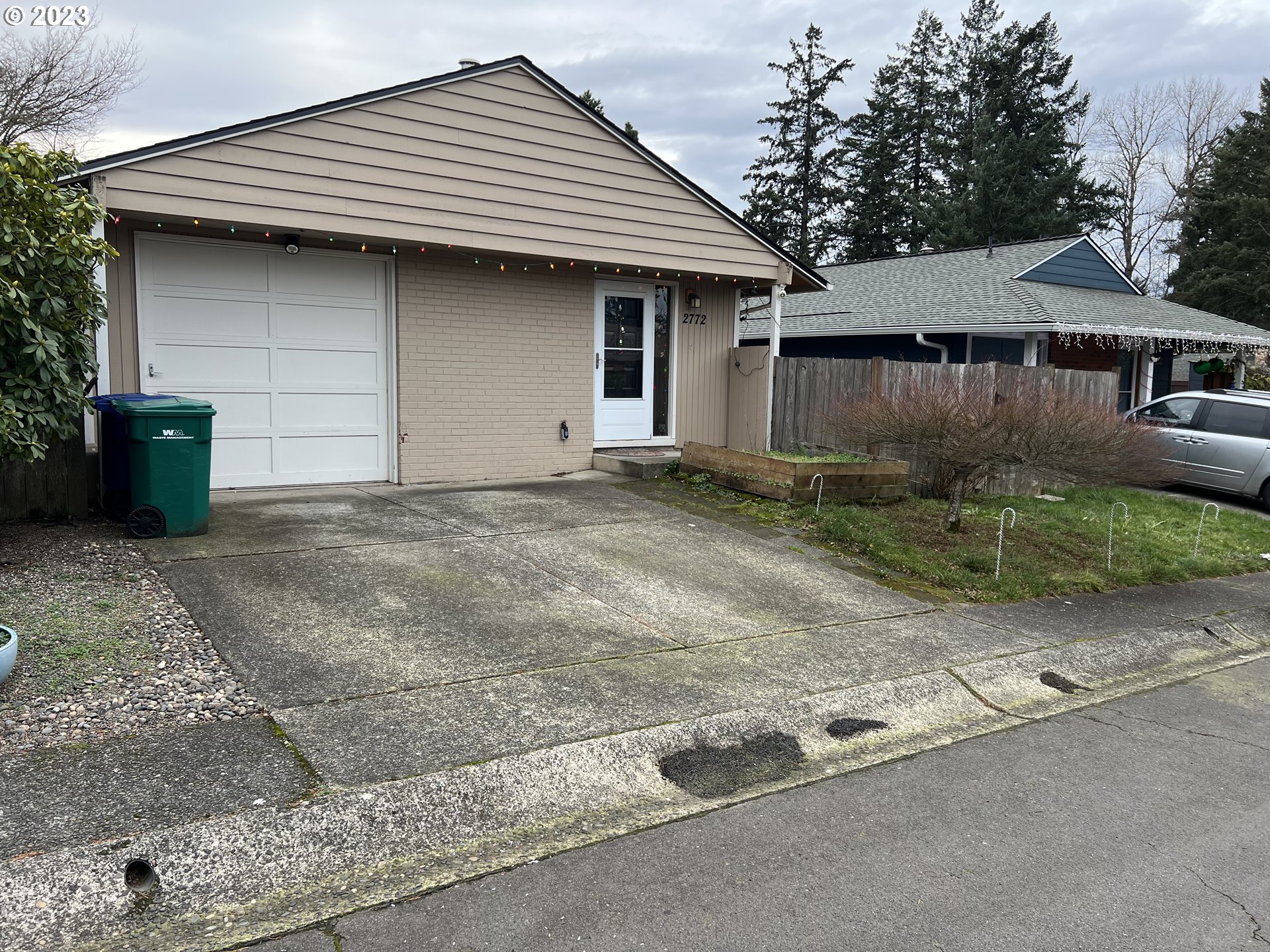 a front view of a house with a garden