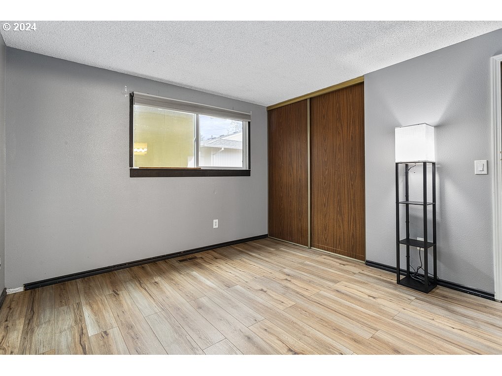 2772 Southwest 18th Place Gresham, OR 97080 - Photo 12 of 16 a view of an empty room with wooden floor and a window