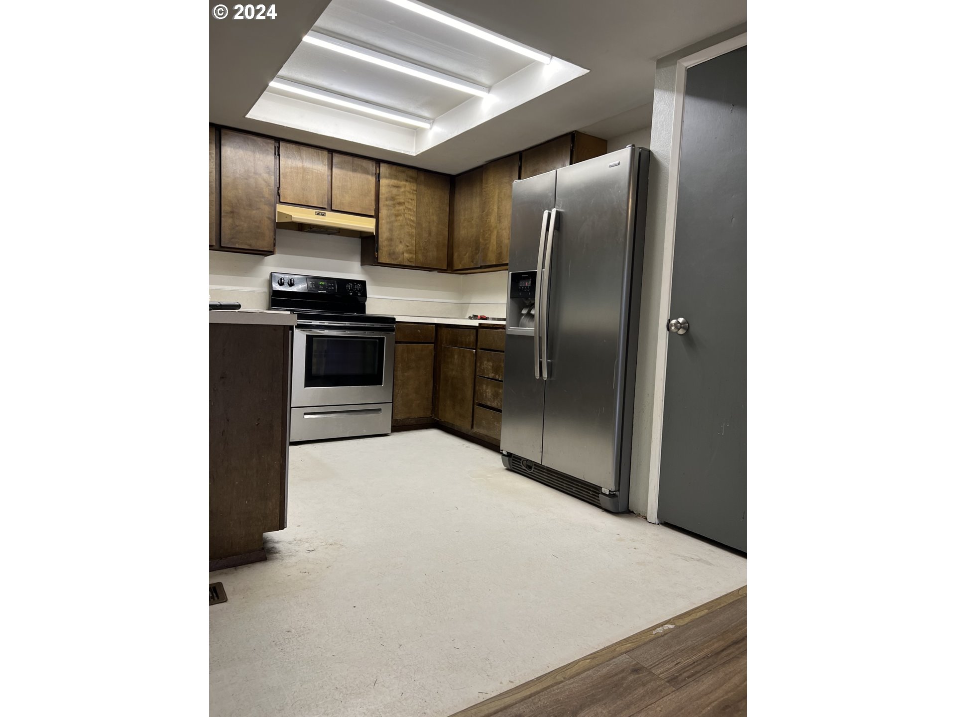 2772 Southwest 18th Place Gresham, OR 97080 - Photo 3 of 16 a kitchen with stainless steel appliances a refrigerator and a stove