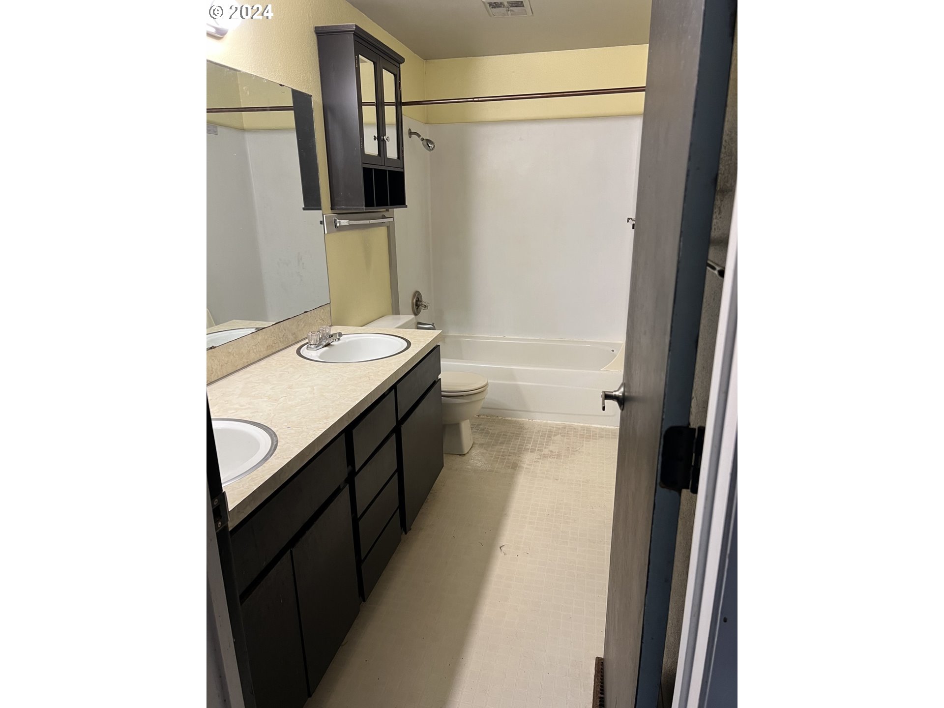 2772 Southwest 18th Place Gresham, OR 97080 - Photo 5 of 16 a bathroom with a granite countertop sink a mirror and a bathtub