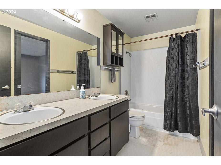 2772 Southwest 18th Place Gresham, OR 97080 - Photo 9 of 16 a bathroom with a double vanity sink toilet and shower