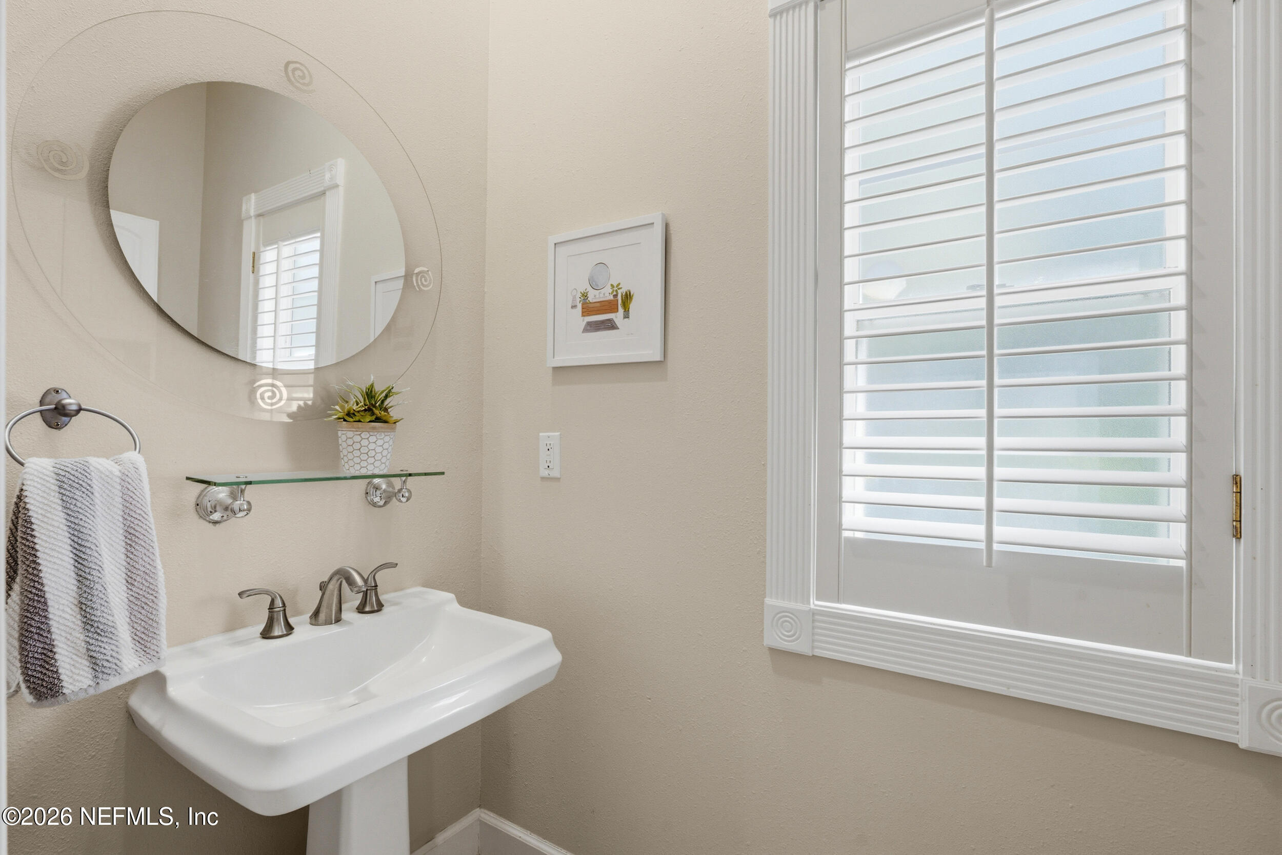 118 3rd Street St. Augustine, FL 32084 - Photo 19 of 77 a bathroom with a sink a mirror and a window