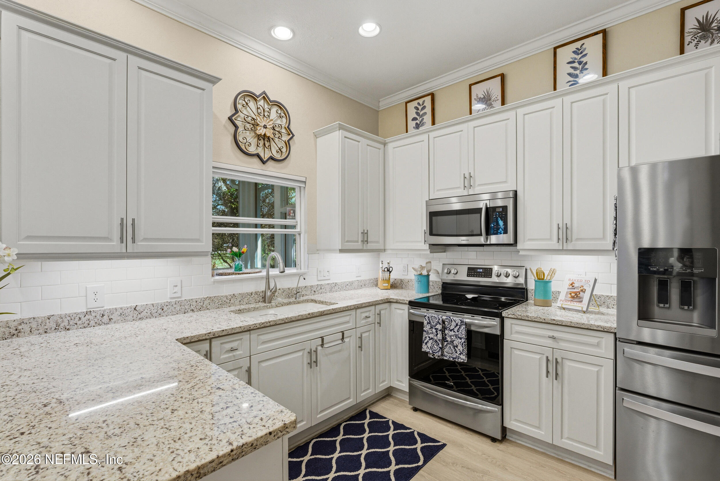 118 3rd Street St. Augustine, FL 32084 - Photo 22 of 77 a kitchen with stainless steel appliances granite countertop a stove a sink and a microwave