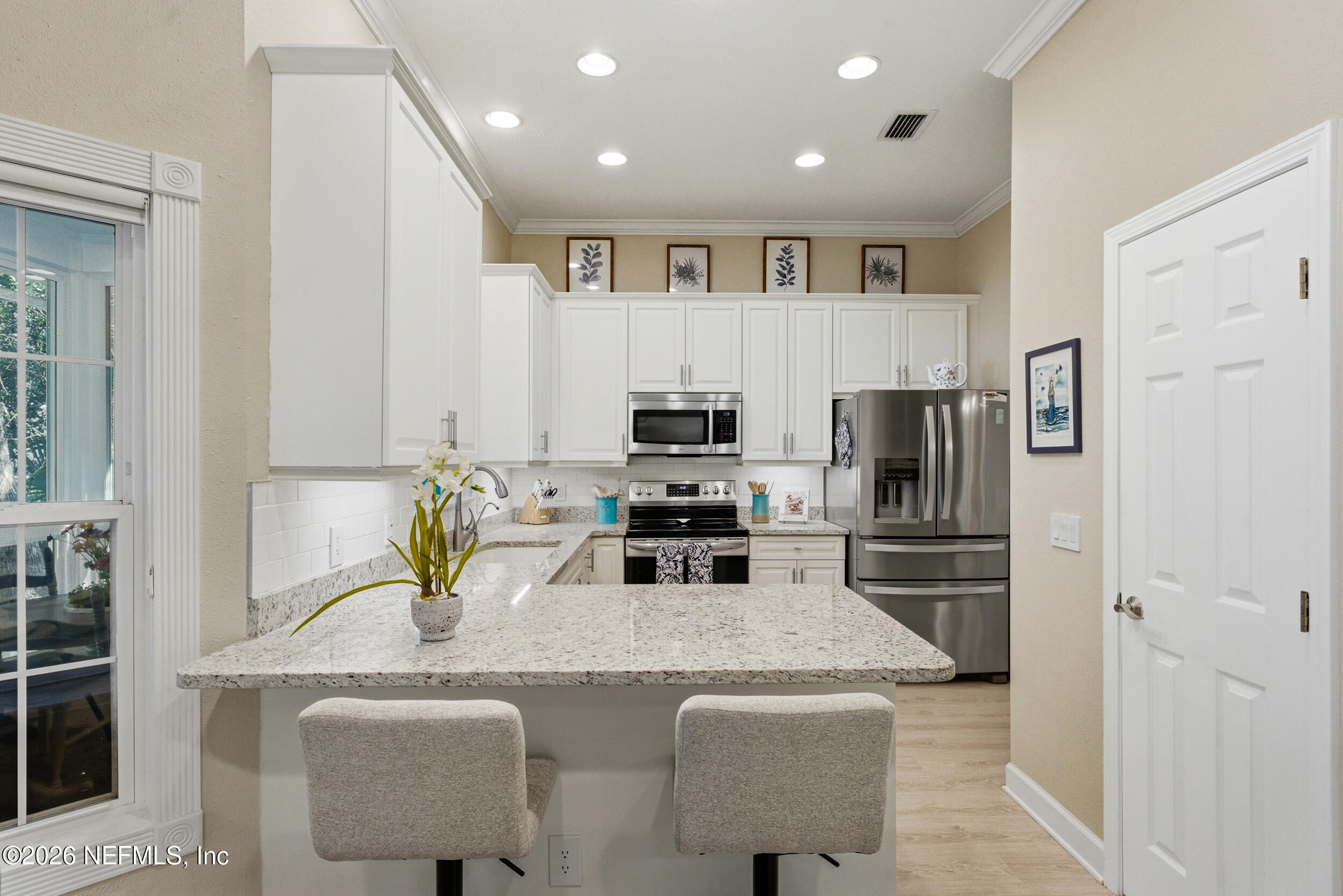 118 3rd Street St. Augustine, FL 32084 - Photo 23 of 77 a kitchen with kitchen island a refrigerator stove microwave and sink