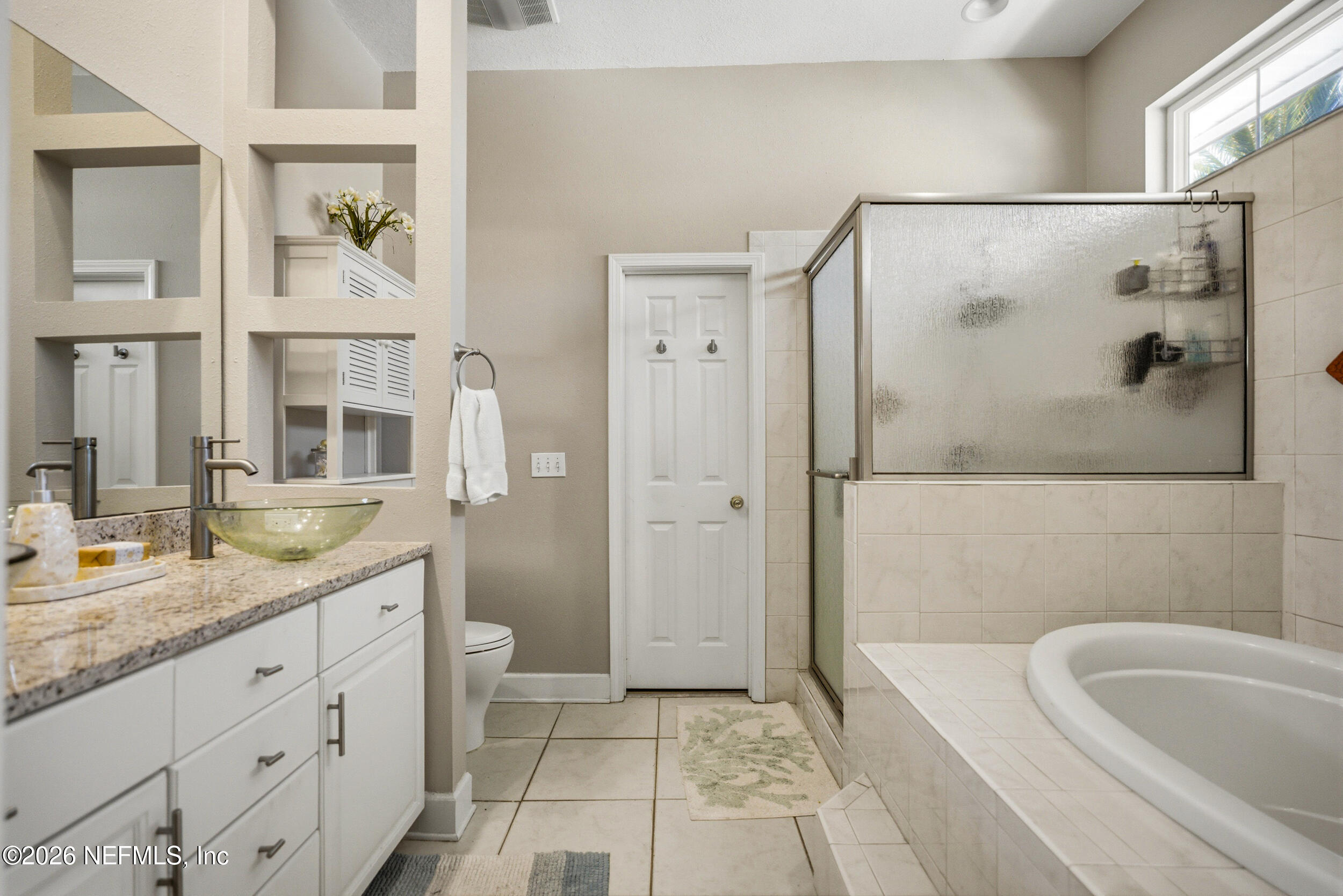 118 3rd Street St. Augustine, FL 32084 - Photo 31 of 77 a bathroom with a granite countertop sink a mirror a bathtub and shower