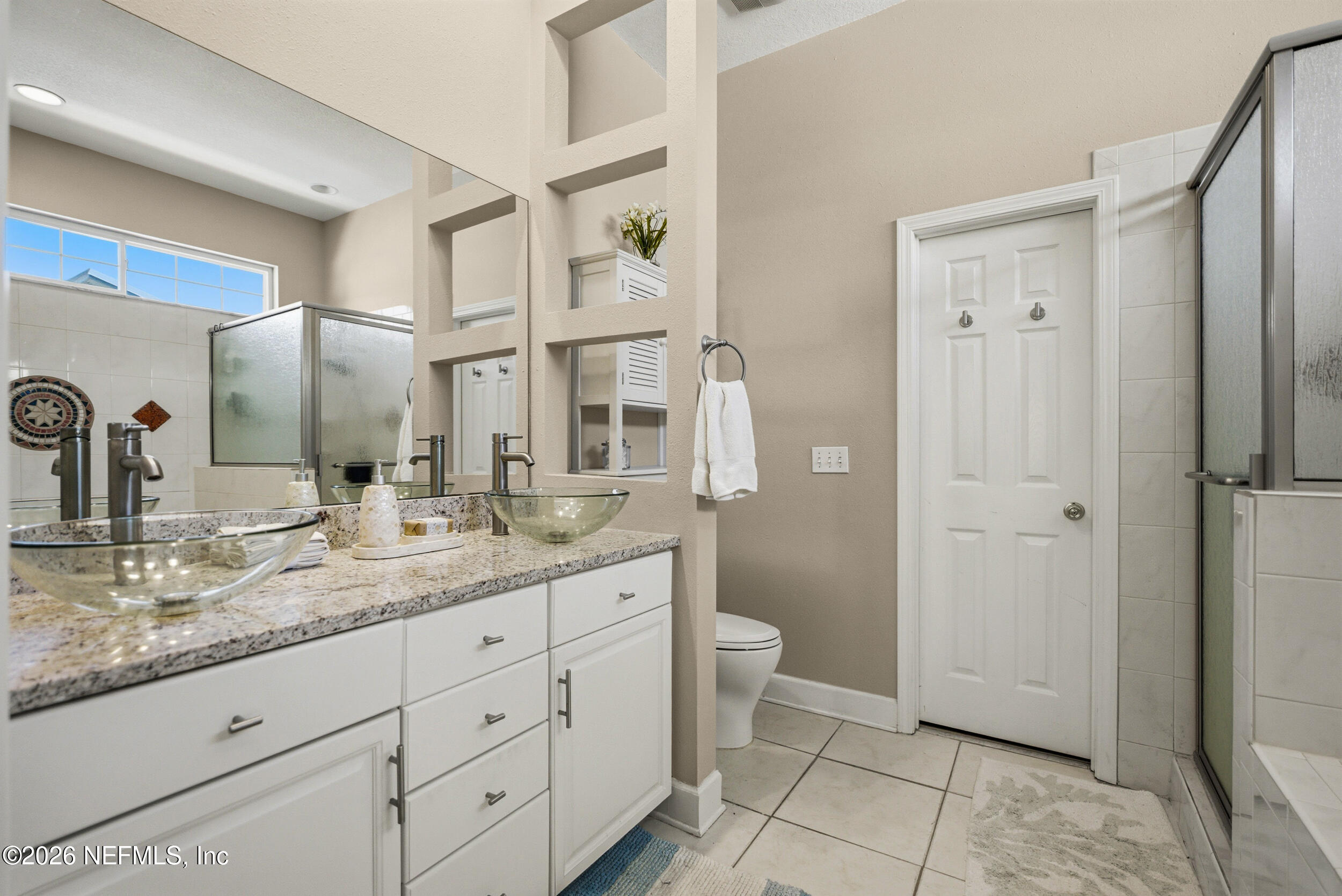 118 3rd Street St. Augustine, FL 32084 - Photo 32 of 77 a bathroom with a granite countertop sink a toilet and a mirror