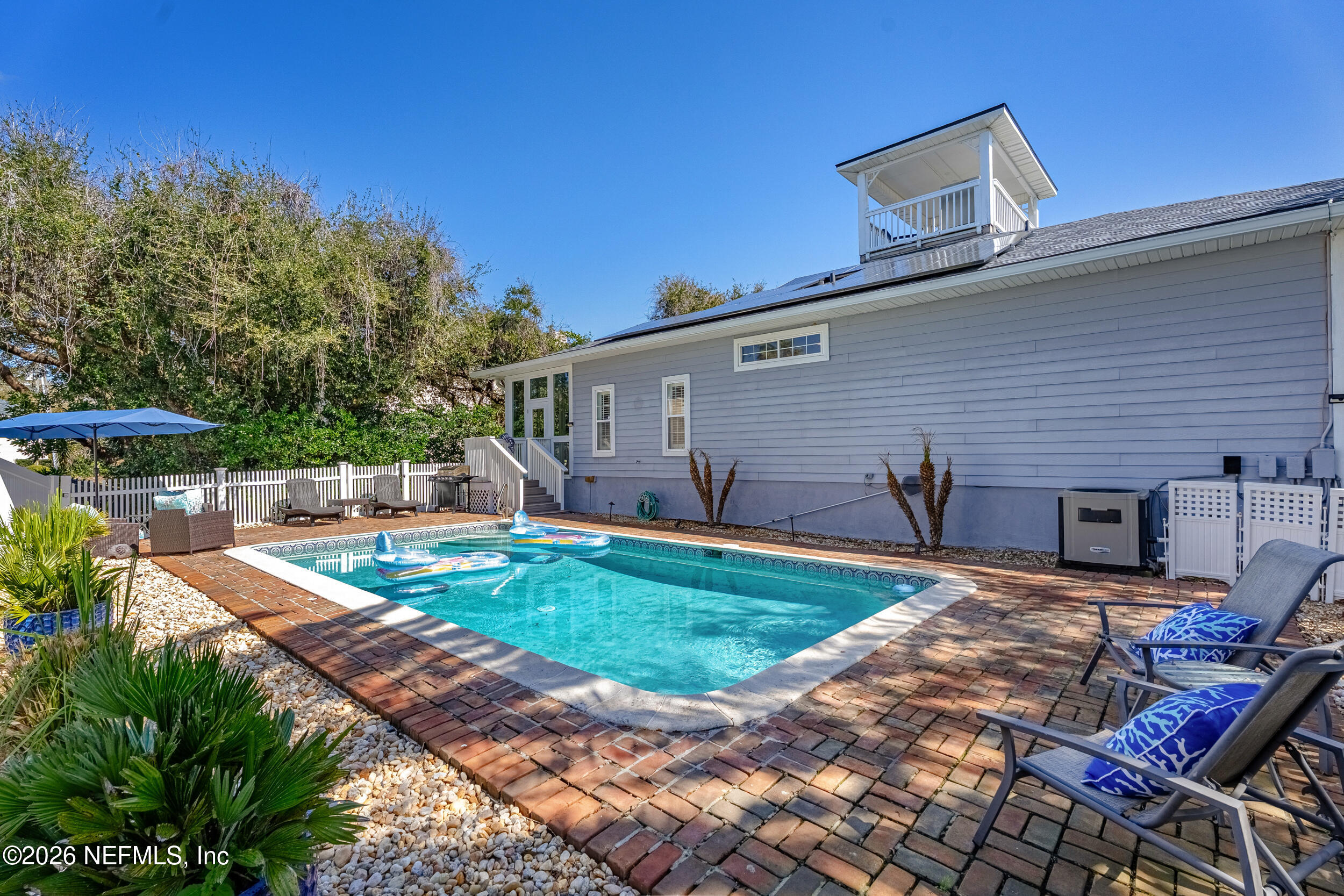 118 3rd Street St. Augustine, FL 32084 - Photo 54 of 77 a view of a backyard with table and chairs potted plants and large tree