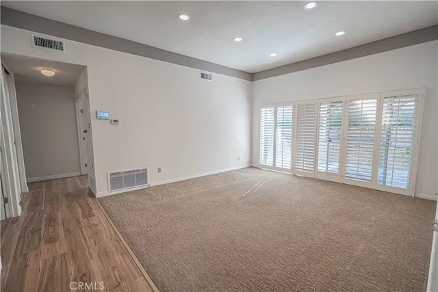 a living room with furniture a flat screen tv and a large window